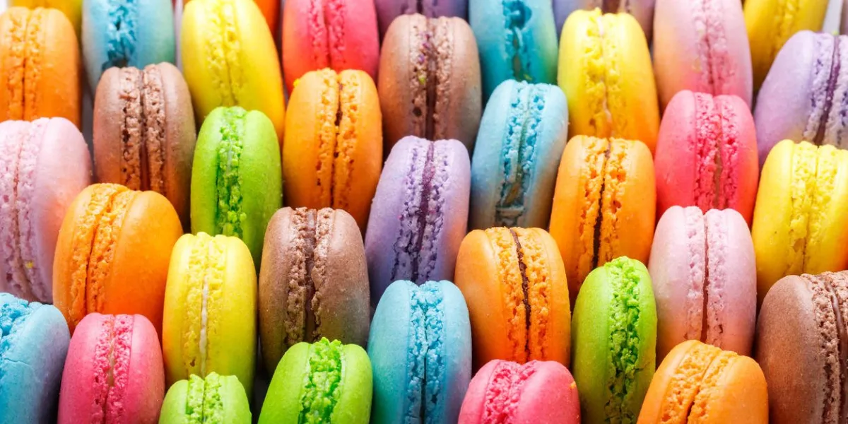 a lot of colourful many macaroons variety closeup for background