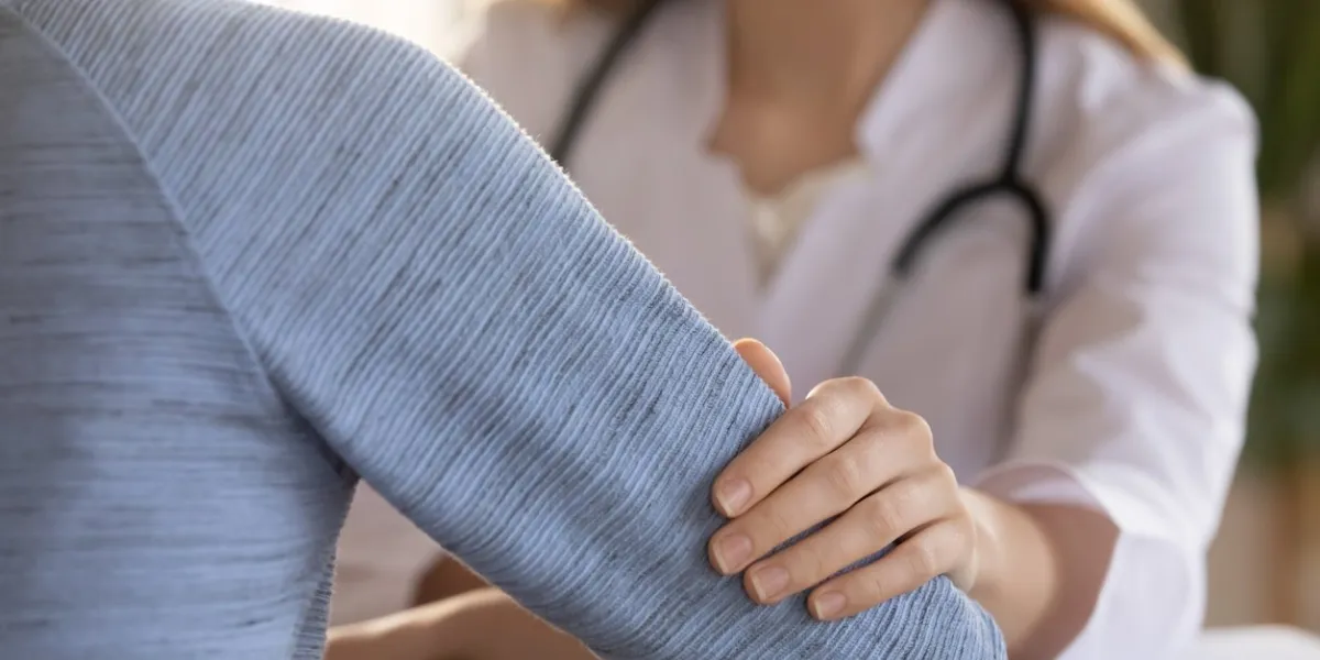 close up of woman doctor touch patient show care and empathy telling bad results news, supportive female gp or physician cheer comfort upset clients at consultation in hospital, healthcare concept