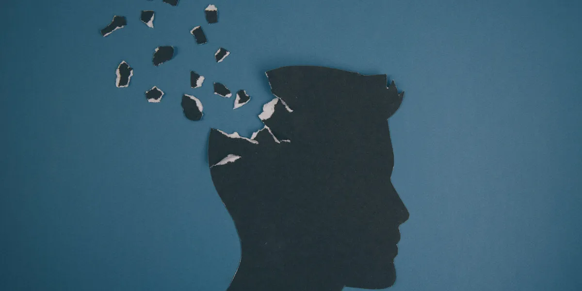 brain disorder symbol presented by human head made form paper creative idea for alzheimer's disease, dementia, memory loss and mental health concept