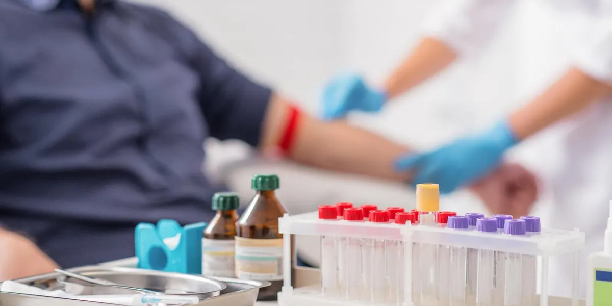 doctor preparing patient for blood sampling focus on blood test tools on table