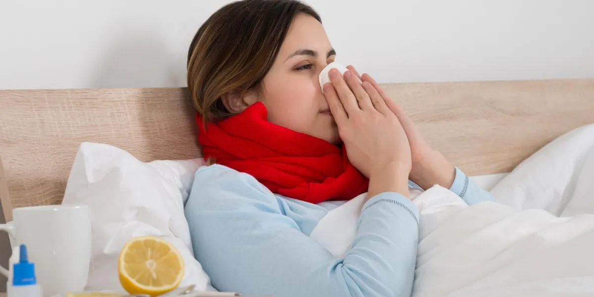 portrait of a young woman with handkerchief blowing her nose