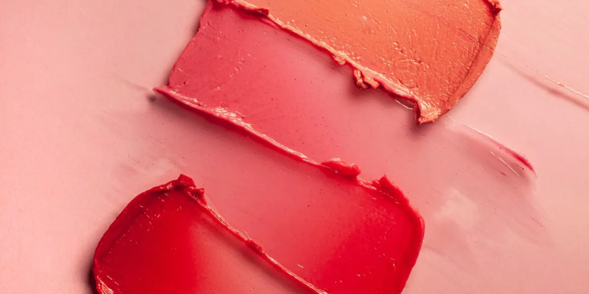 smudged red purple pink textured tint or lipstick on multi-colored pink background