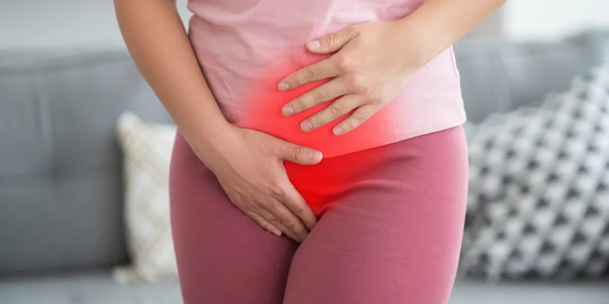 menstrual pain, woman with stomachache suffering from pms at home, endometriosis, cystitis and other diseases of the urinary system, painful area highlighted in red