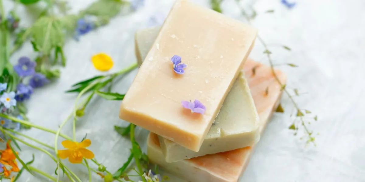 natural handmade soap bars with organic medicinal plants and flowershomemade beauty products with natural essential oils from plants and flowers, top view closeup photo