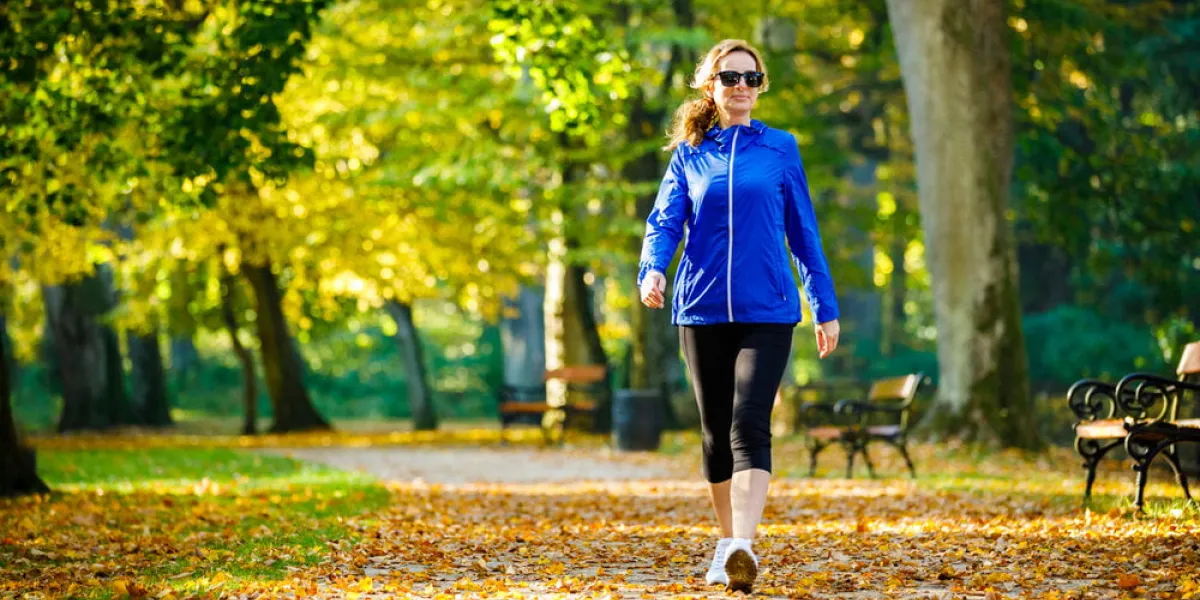 mid aged woman running in city park