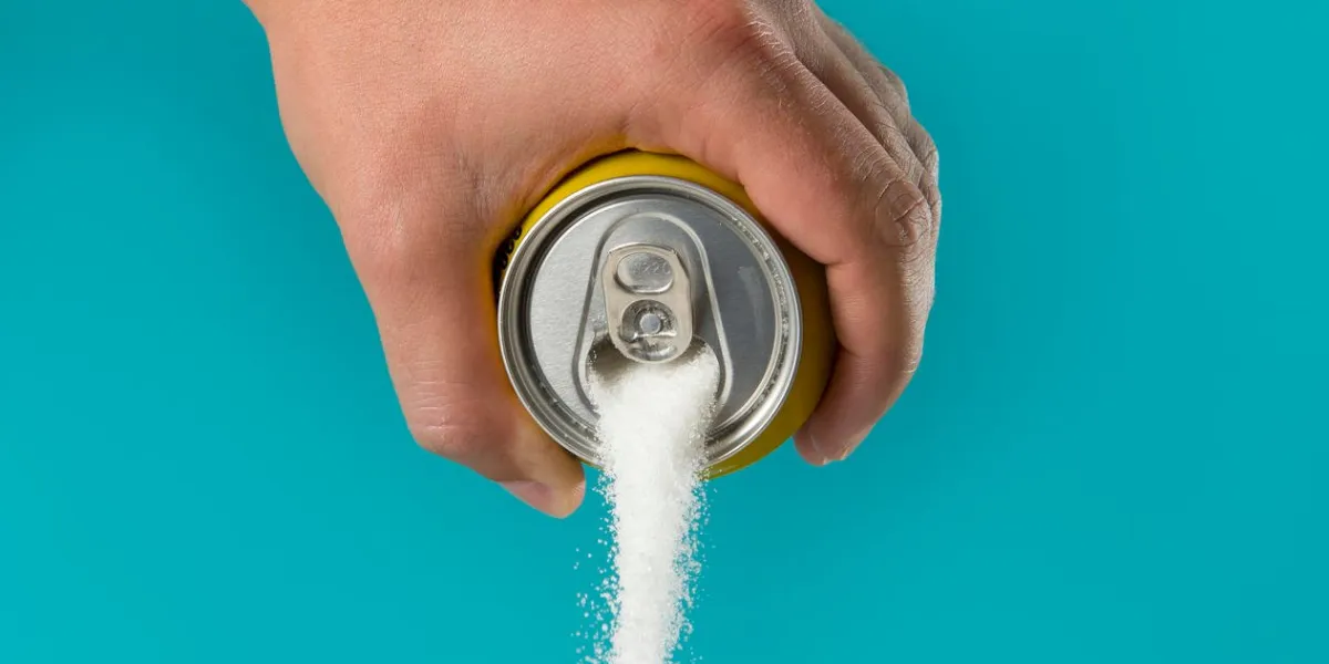 man hand holding lemon refresh drink can pouring sugar stream in sweet and calories content of soda and energy drinks concept in unhealthy nutrition and diet concept