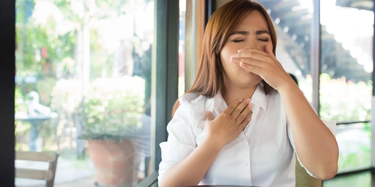 woman has sore throat at coffee shop