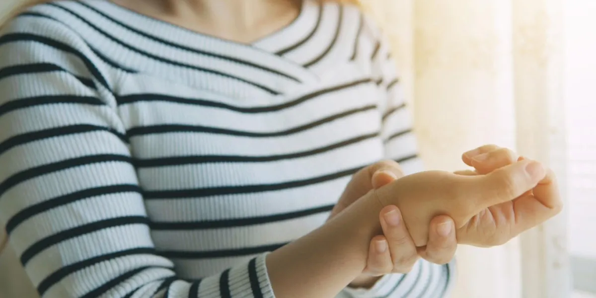 woman massaging her arthritic hand and wrist