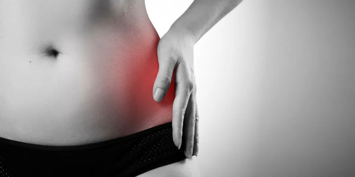 pain in the left side pain in the woman body black and white photo with red dot