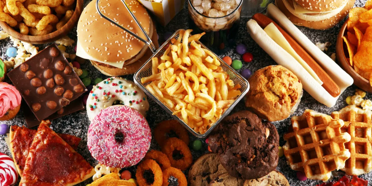 unhealthy products food bad for figure, skin, heart and teeth assortment of fast carbohydrates food with fries and cola