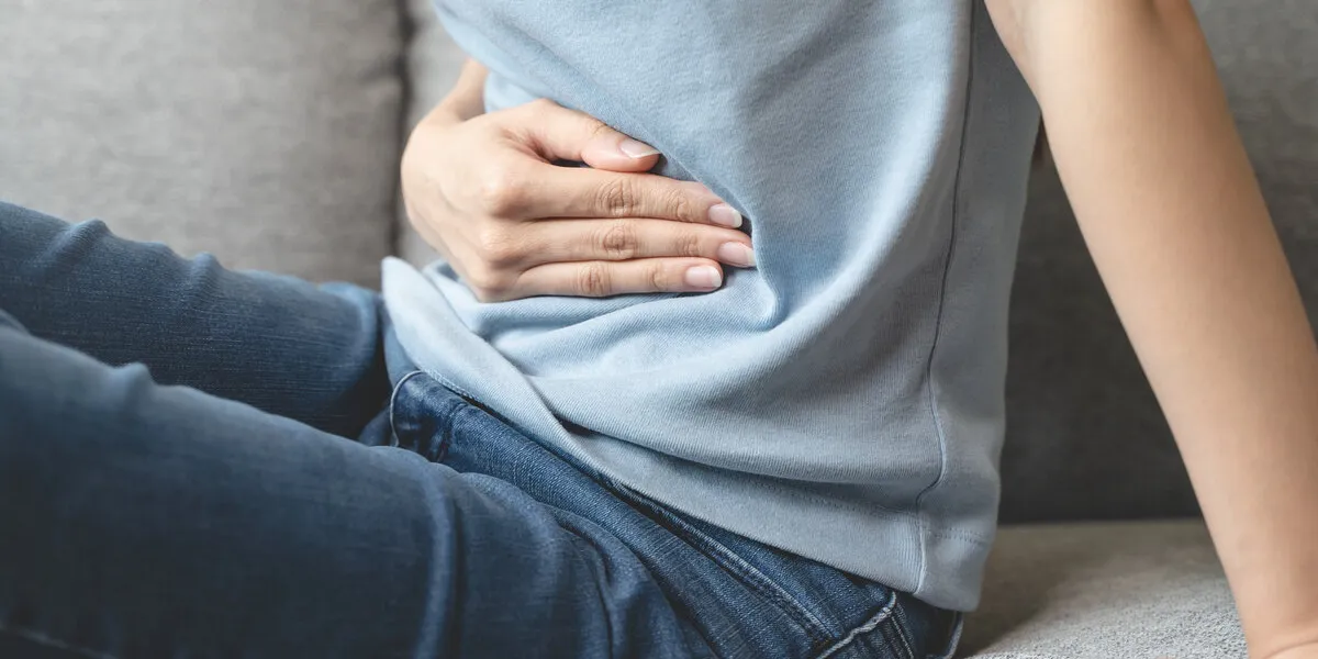 close up woman suffering stomach pain from food poisoning