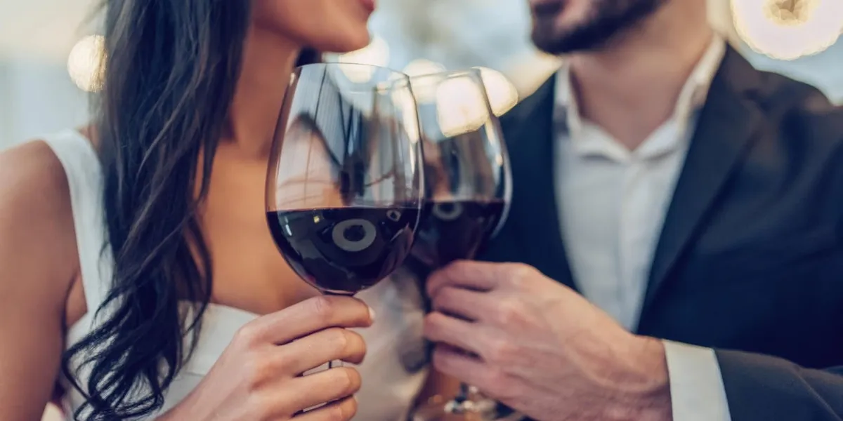 cropped image of loving couple is spending time together in modern restaurant attractive young woman in dress and handsome man in suit are having romantic dinner celebrating saint valentine's day