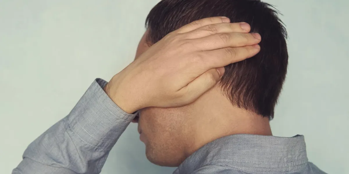 ear pain in a man a young patient is holding onto a diseased ear earache otitis