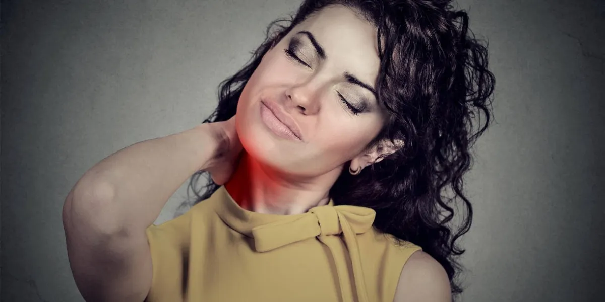 back and spine disease woman massaging painful neck colored in red isolated on gray wall background human face expression chronic fatigue disease