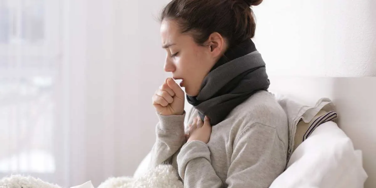 young ill woman in bed at home