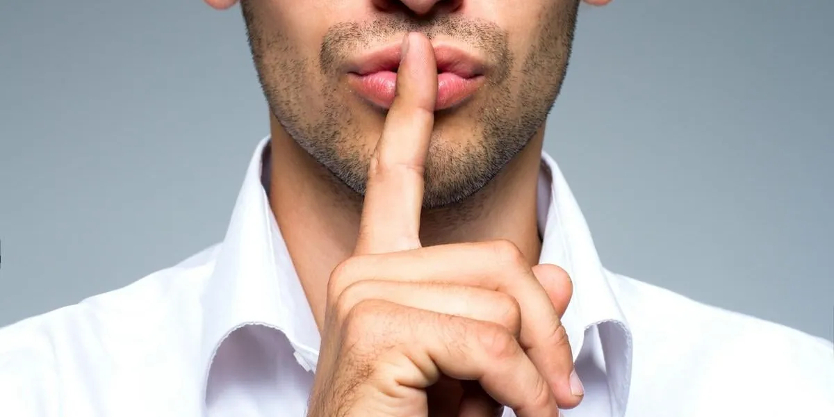 businessman silent quiet gesture with finger