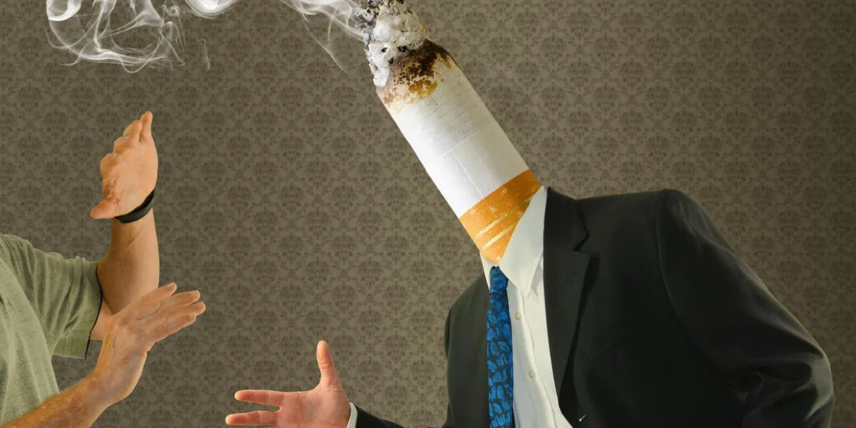 a man has a stinky smoking cigarette butt for a head representing the disgusting habit smoking cessation and motivational concept using humor