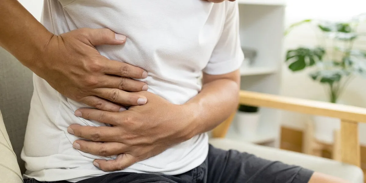 asian male patient with abdominal pain on right side belly,painful in abdomen,irritable bowel,middle-aged man holds under the ribs,stomach ache,cirrhosis of the liver disease,liver cancer concept