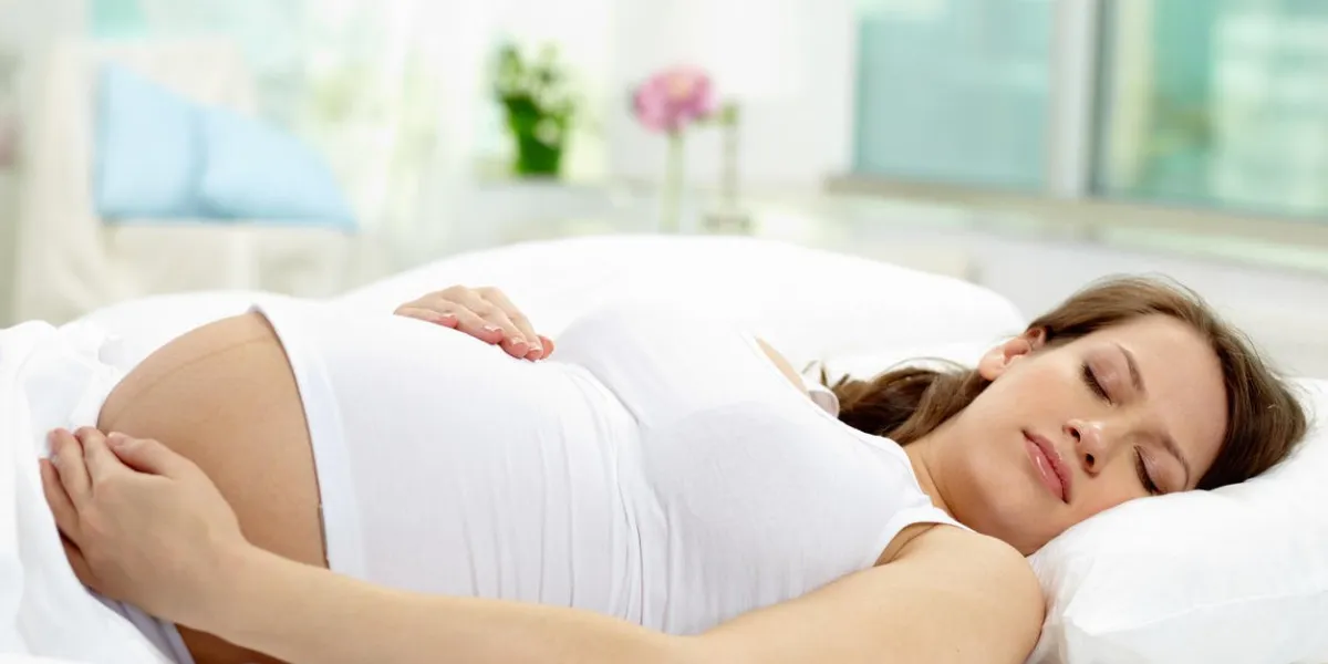 photo of beautiful pregnant woman sleeping in bed