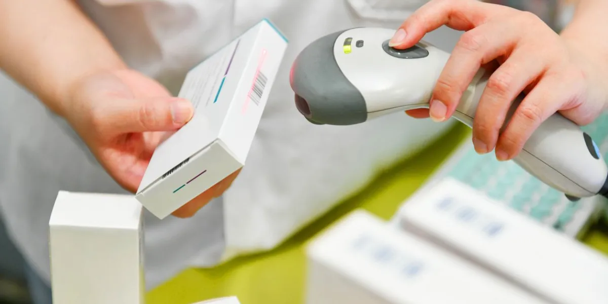 pharmacist scanning barcode of medicine drug in a pharmacy drugstore