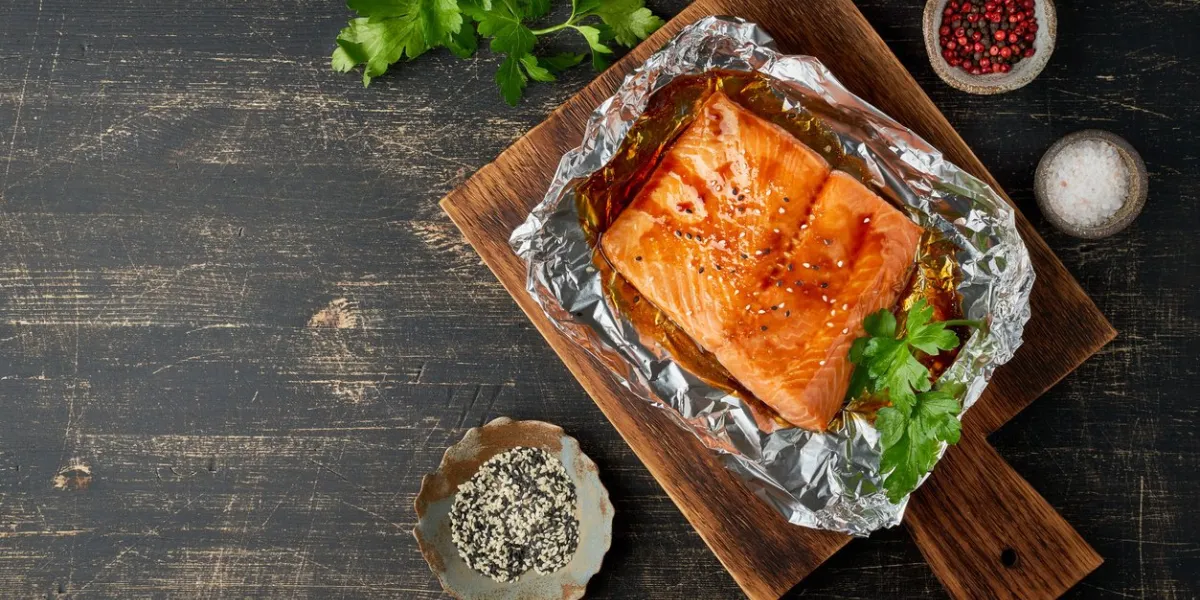 foil pack dinner with fish fillet of salmon copy space healthy diet food, keto diet, mediterranean cuisine oven-baked hot dinner top view, close up