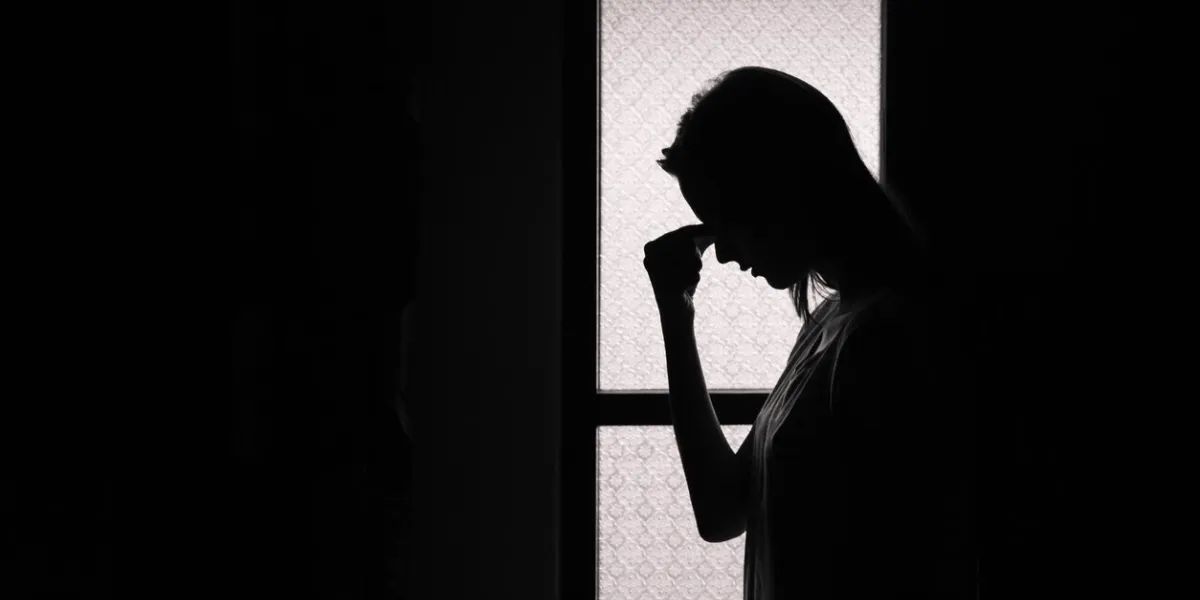 depressed young woman in a dark room