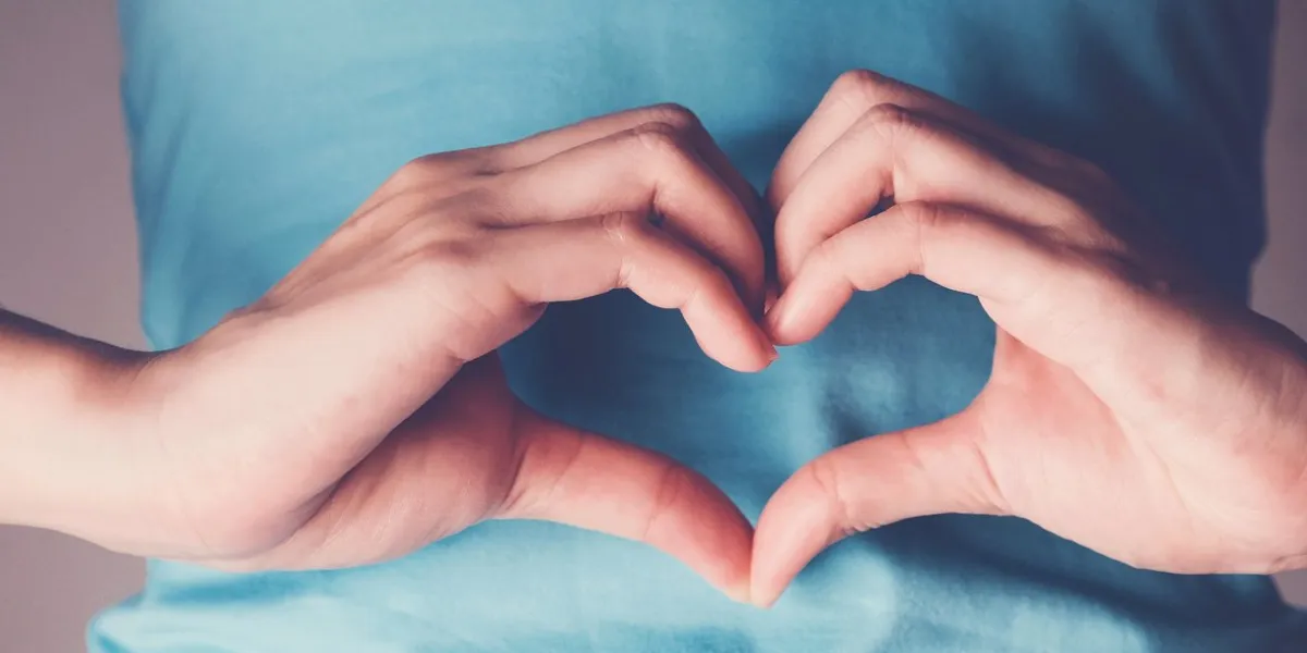 woman hands making a heart shape on her stomach, healthy bowel digestion, probiotics for gut health