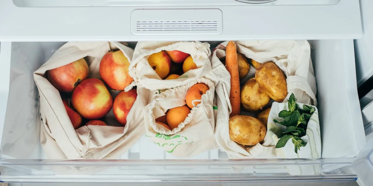 zero waste concept fresh vegetables and fruits in eco cotton bags (tote bag) in a refrigerator from market shopping concept top view