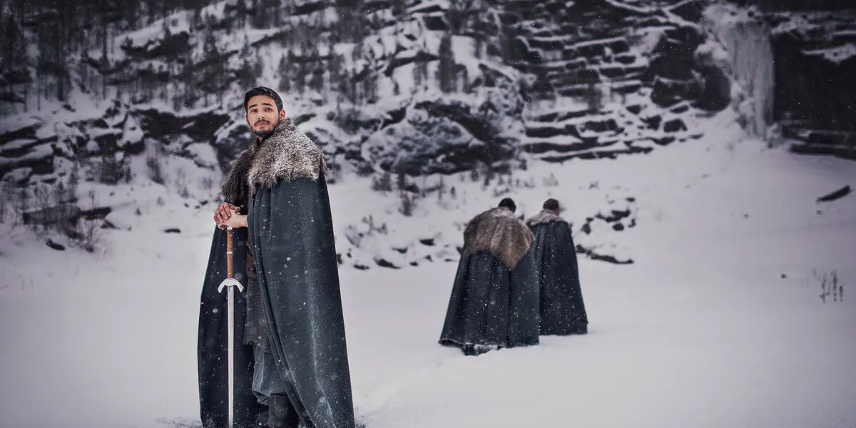 medieval knight with sword in armor in winter landscapes