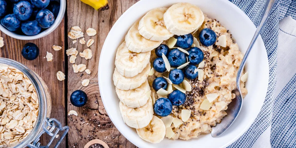 breakfast  oatmeal with bananas, blueberries, chia seeds and almonds top view