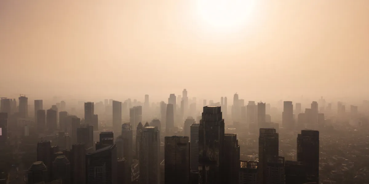 jakarta - indonesia october 12, 2018  silhouette of jakarta cityscape at dusk time with air polluted