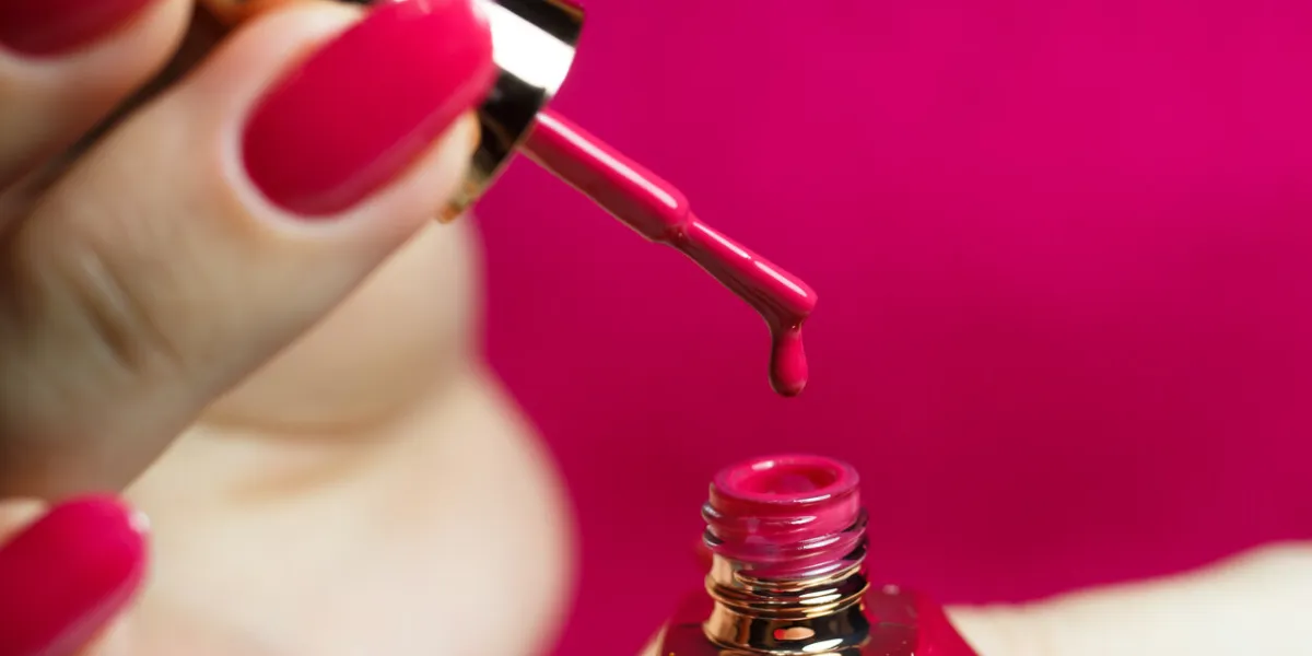 drop of manicure polish close-up red manicure with gel polish, beautiful female nails