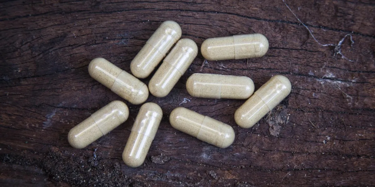many capsule pill on wooden background