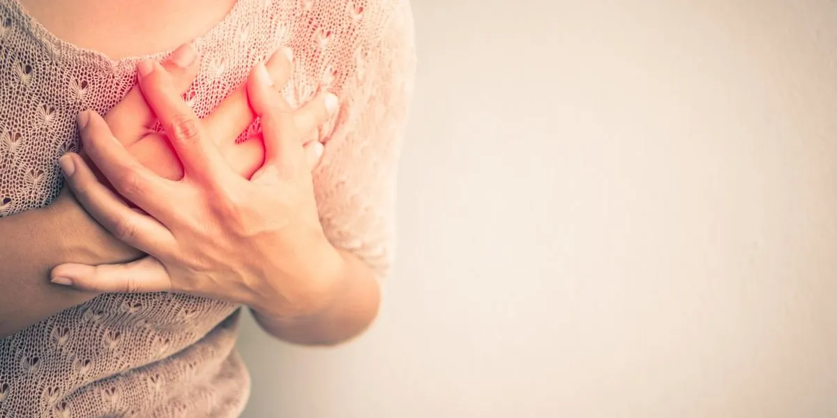 woman having a pain in the heart attact medical and health care concept