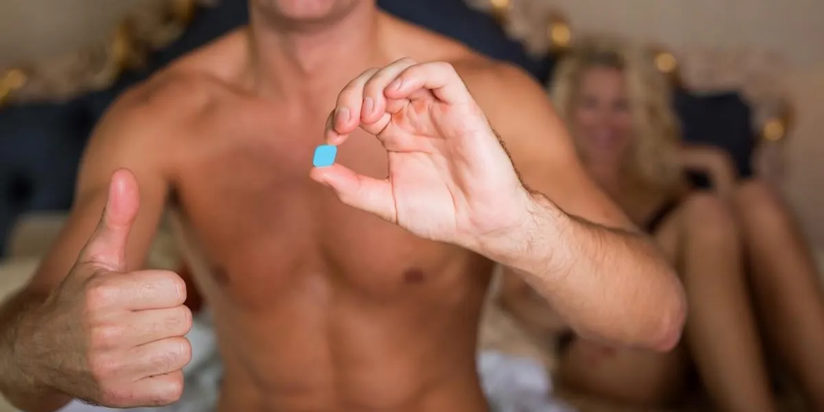 happy man showing medicine pill
