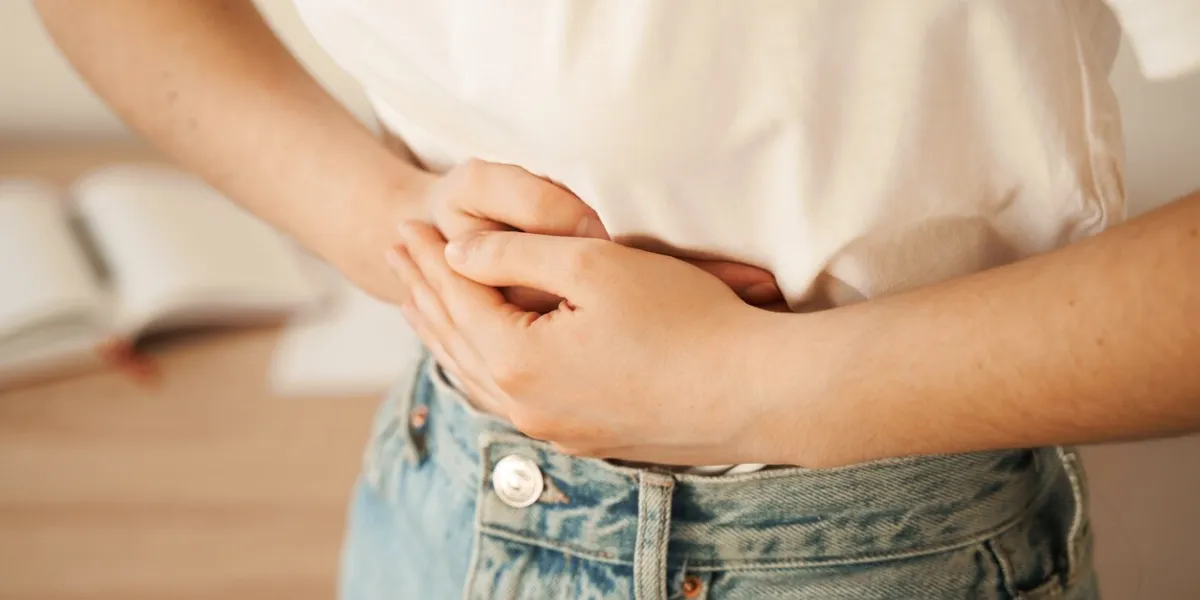 stomach pain gastritis is an inflammation, irritation, or erosion of lining of stomach sick girl hold abdomen because it hurts