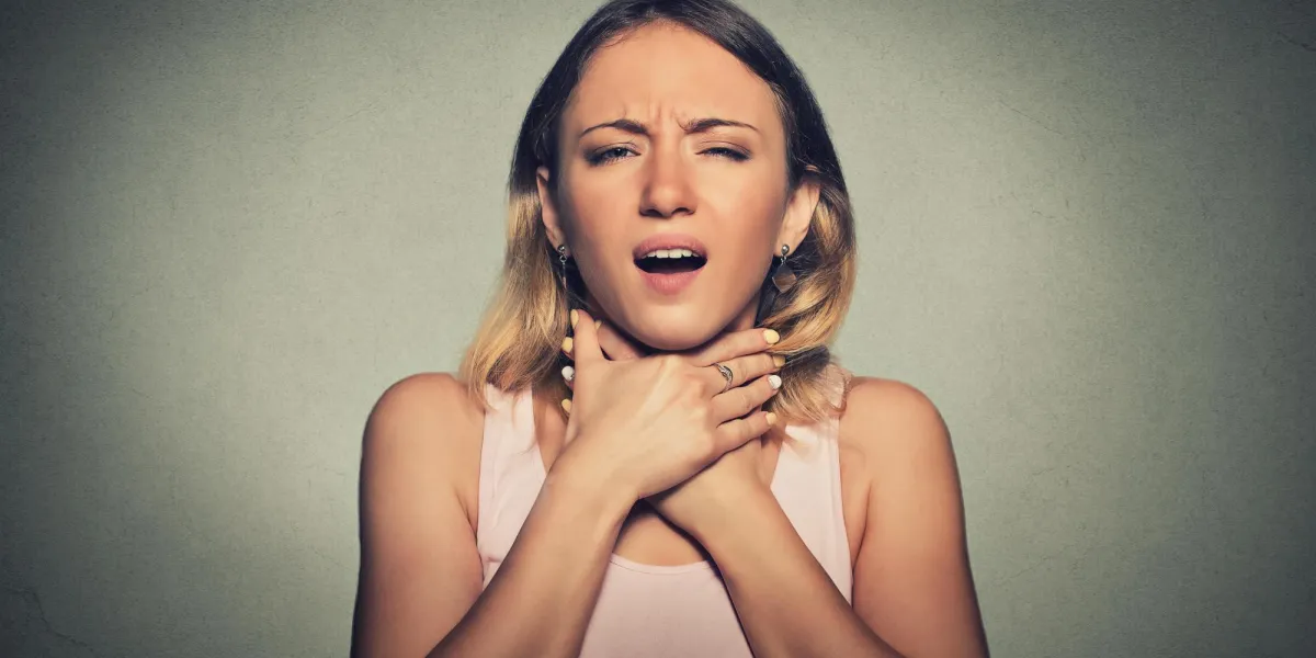 young woman having asthma attack or choking can't breath