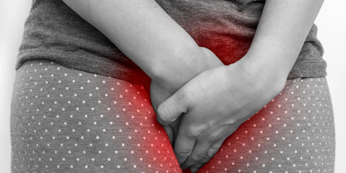 woman with incontinence problem is holding her crotch - black and white incontinence concept