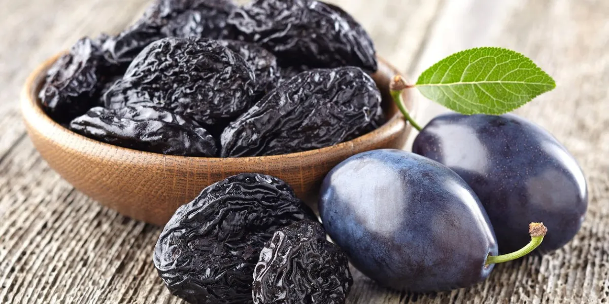 plum with prunes on a wooden board