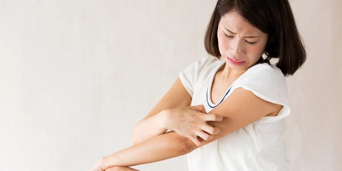 腕を掻く女性