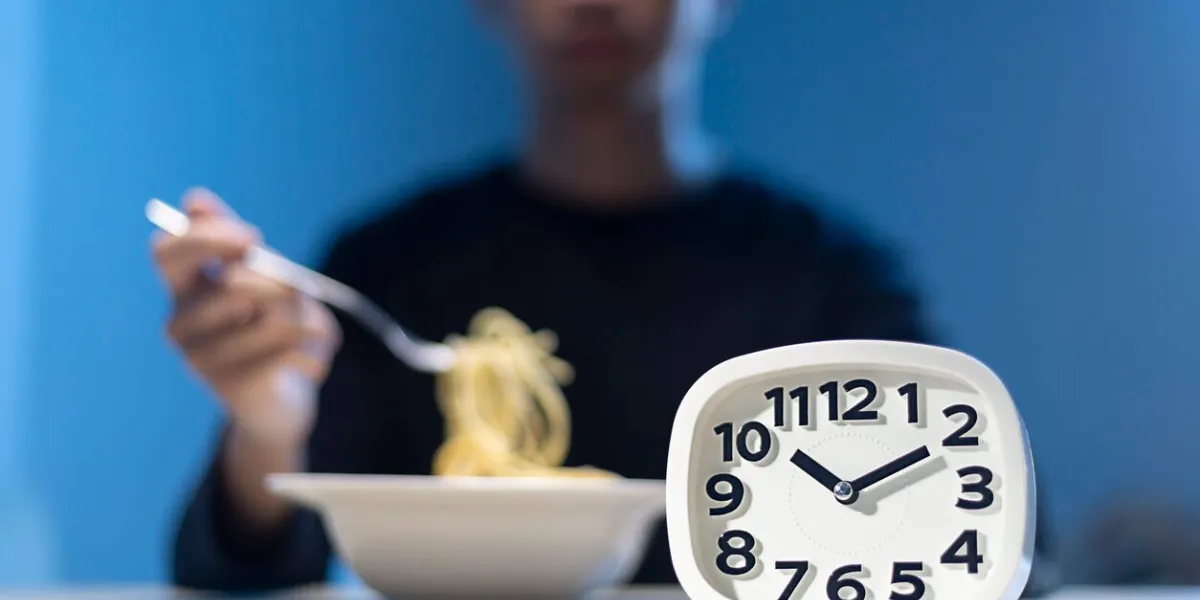 man eating late night time alone at home or apartment scene