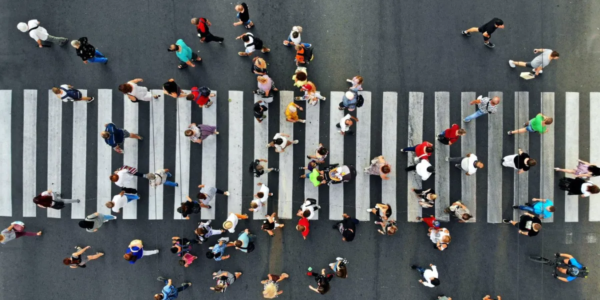 aerial people crowd motion through the pedestrian crosswalk top view from drone