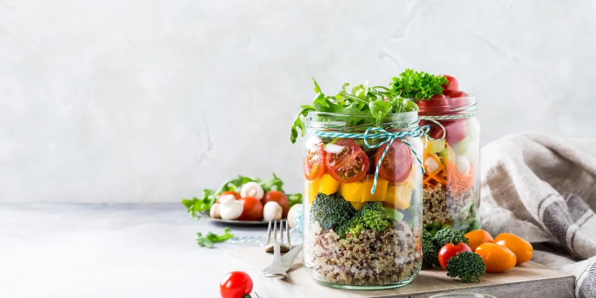 homemade salad in glass jar with quinoa and vegetables healthy food, diet, detox, clean eating and vegetarian concept with copy space