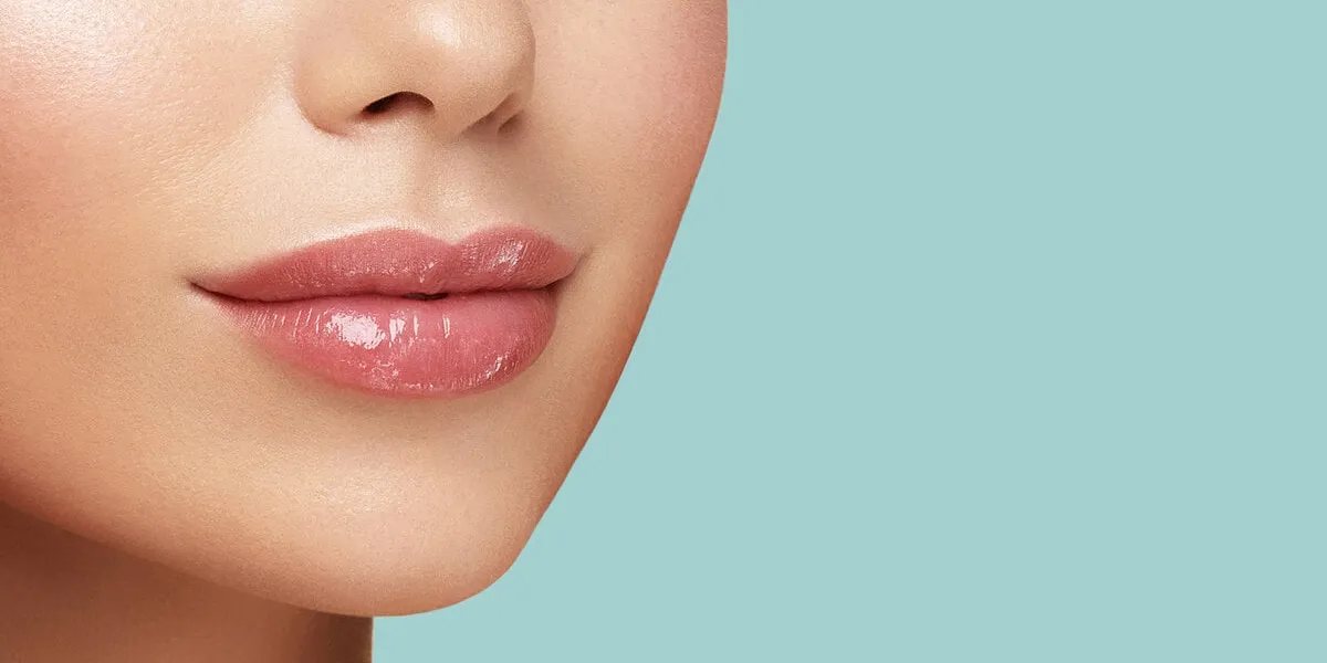 close up photo of women lips cosmetology beauty injetion procedure hyaluronic acid lip protection balm hygienic lipstick