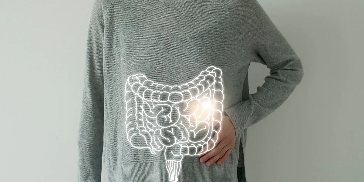 woman in casual grey clothes suffering from indigestion pain, highlighted vector visualisation of intestine