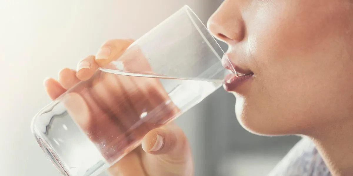 young woman drinking pure glass of water