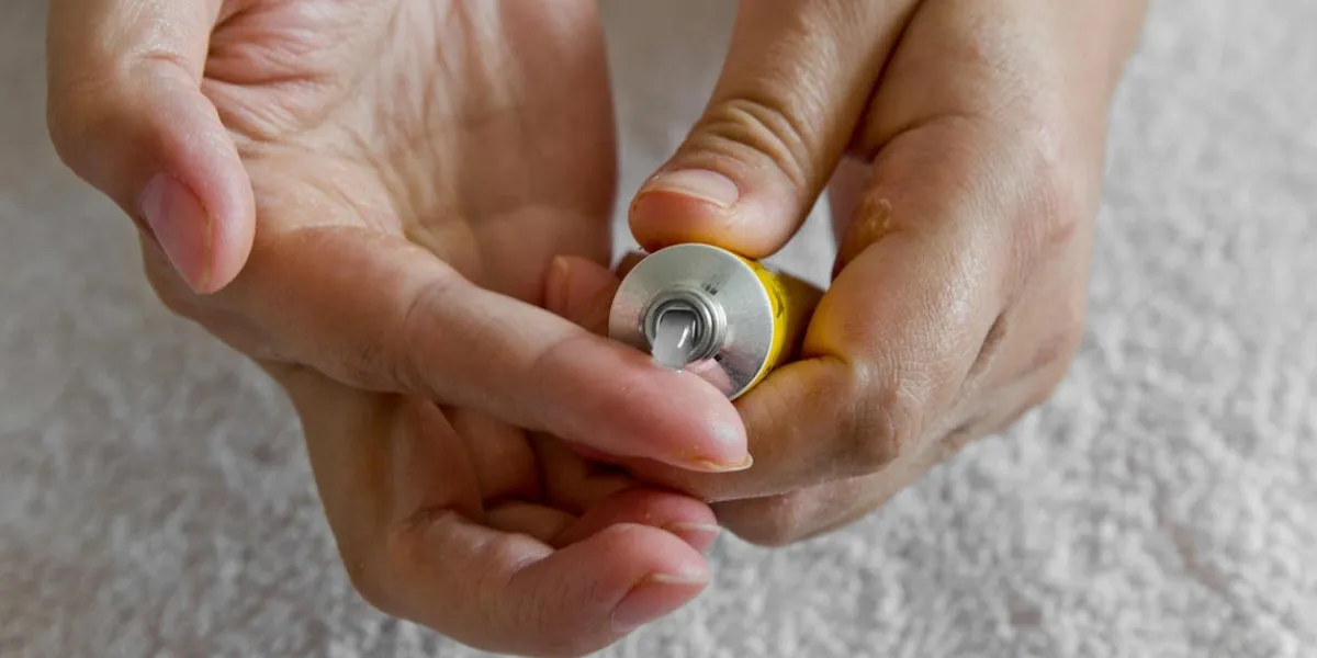 ointment on hand applying the ointment and emollient cream in the treatment and hydration of the skin