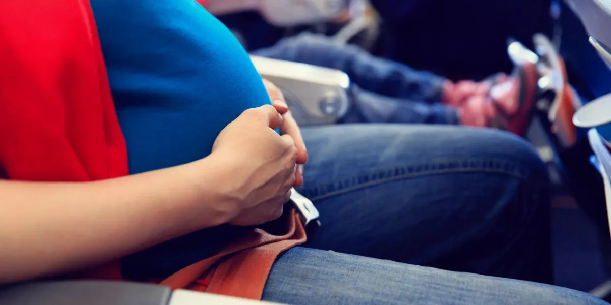 pregnant woman travel by plane, expectant mother vacation concept