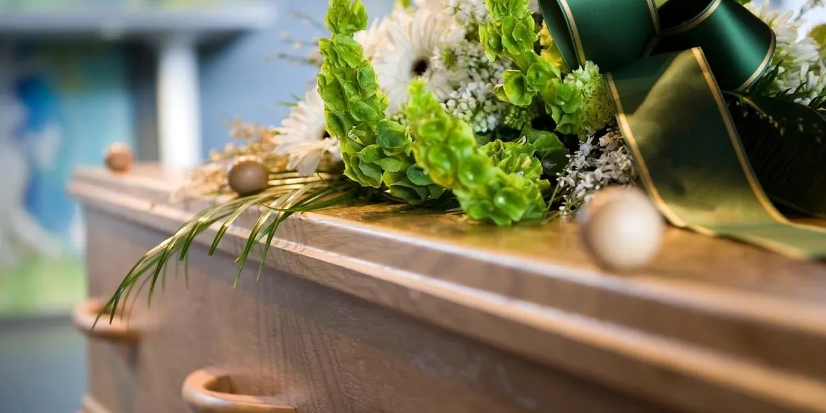 a coffin with a flower arrangement at a mortuary