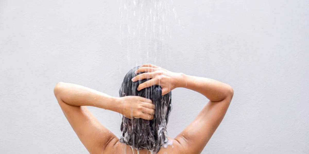 beautiful woman's hand she was washing her hair and nourishing her scalp shampoo and conditioner